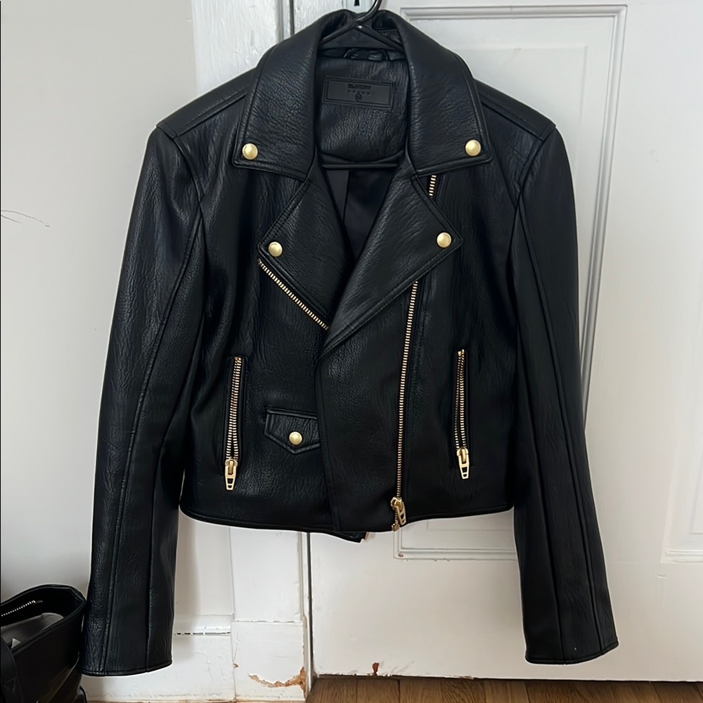 Brand new never worn black leather jacket with gold details. So cute!